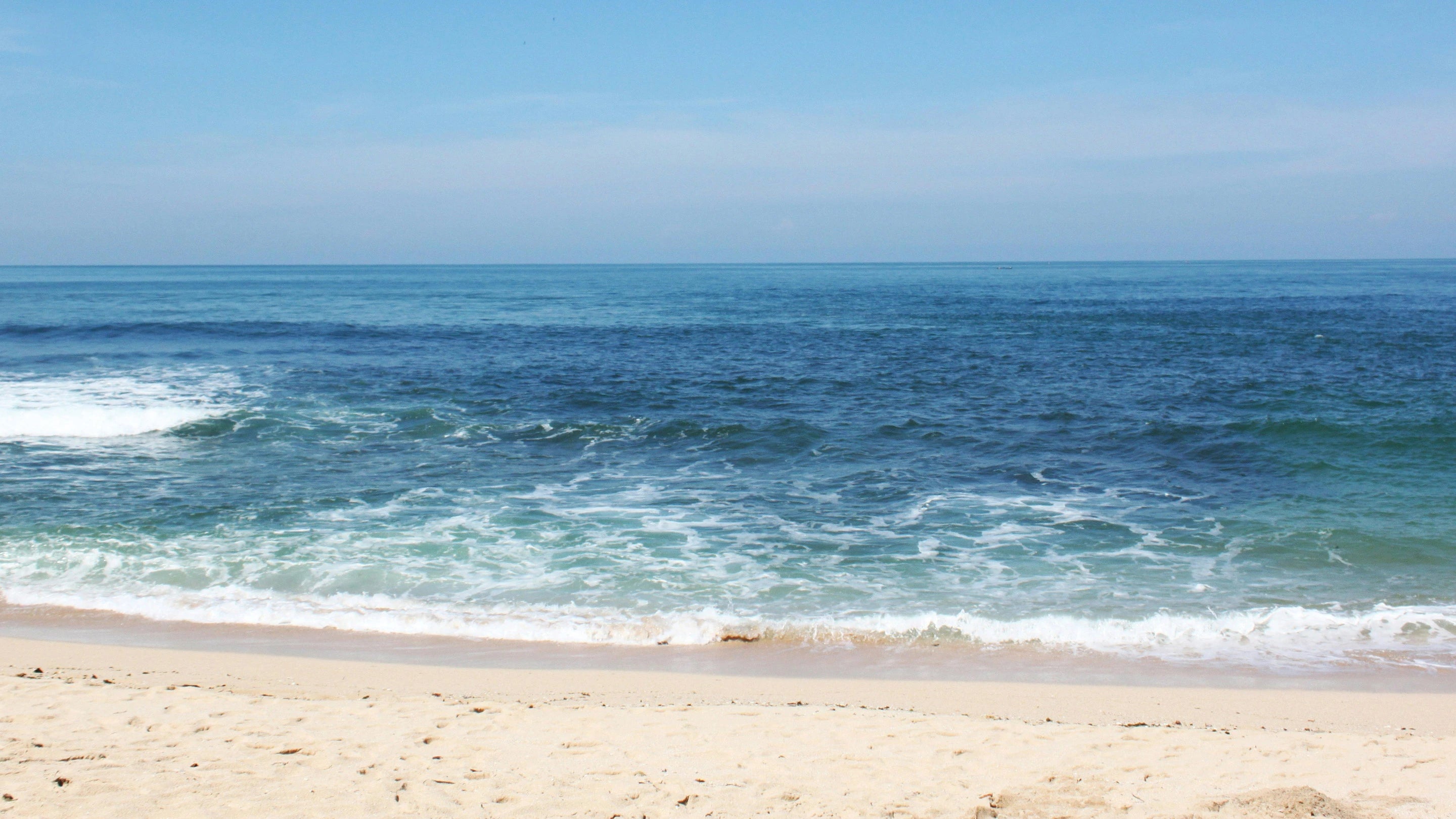 Beach with waves and clear blue sky