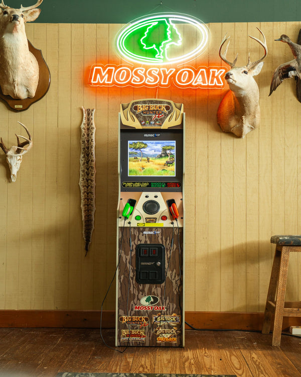 A front-on shot of the Big Buck Hunter arcade game under a neon sign.